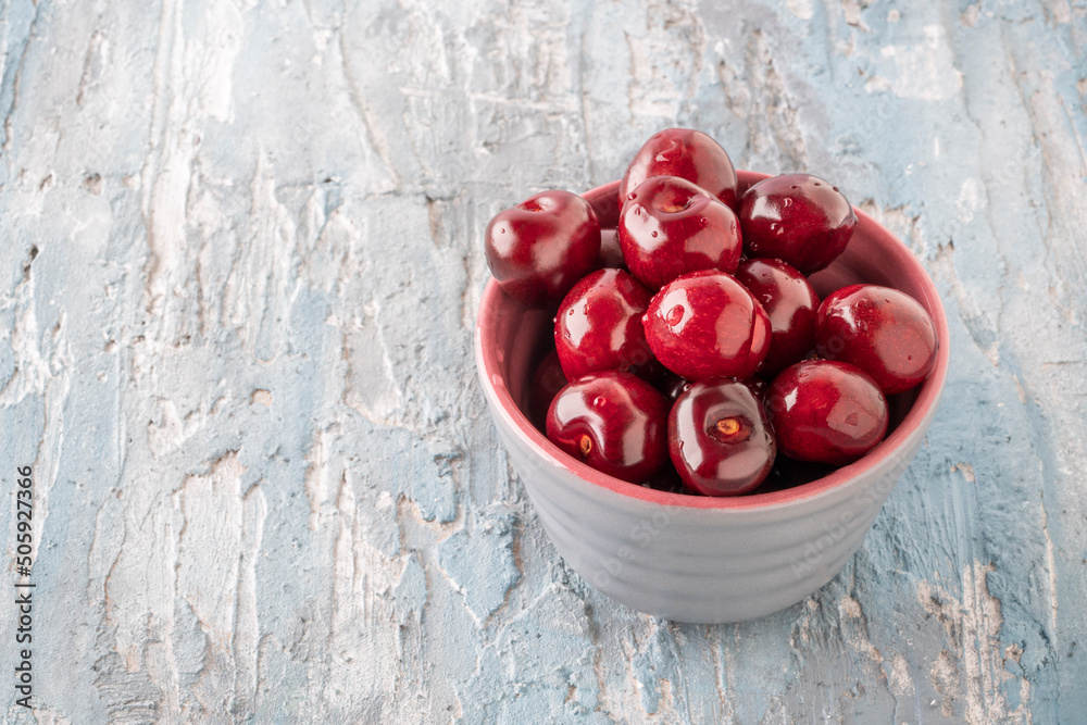 delicious cherry fruits in a gray bowl on table delicious cherry fruits in a gray bowl on table