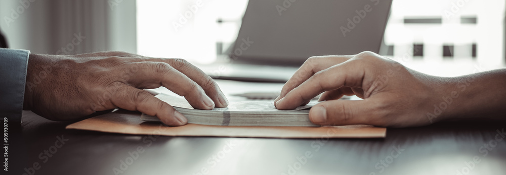 Φωτογραφία Businessmen give dollars to bribe employees in signing contracts to buy illegal land and real estate, Business fraud and social injustice, corruption and bribery concept