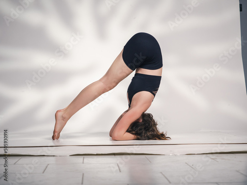 One young Cacucasian woman, exercising yoga. photo