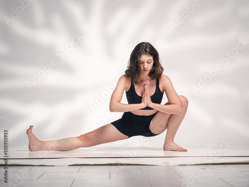 One young Cacucasian woman, exercising yoga. photo