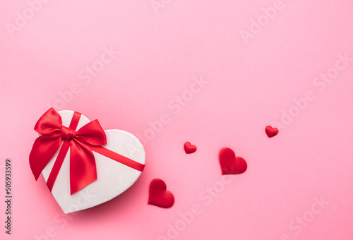 Love Valentine's Day. Love background. Gifts in the form of hearts on a pink background with the inscription love. Copy space for text. The concept of romance and love. square format. word