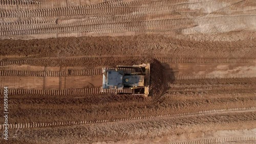 Dozer has been recovering the landscape around the open pit. Process of restoring land. Bulldozer at mine reclamation once mining sand is completed. Clearing land. 