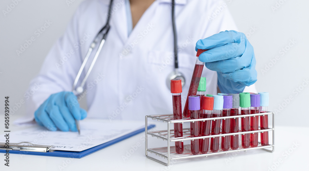 Fototapeta premium Scientists or physicians analyze the blood sample in vitro to prepare a vaccine against a new strain of viruses, Examination with blood test tubes, Vaccine Research and Science concept.