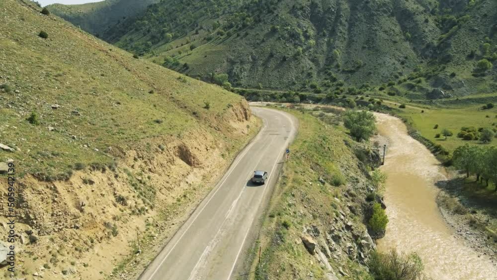 top view of a passenger car that is driving on a mountain road top view of a passenger car that is driving on a mountain road