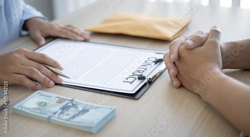 Businessmen give dollars to bribe employees in signing contracts to buy illegal land and real estate  Business fraud and social injustice  corruption and bribery concept.