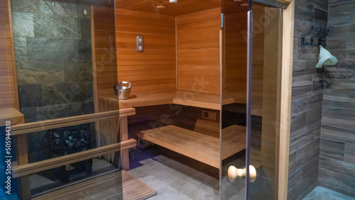 Traditional finnish sauna made from wood. Empty interior of wooden spa cabin with hot dry steam.