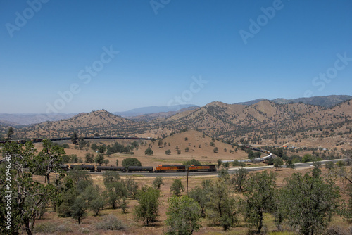 The Tehachapi Loop where Trains Cross over themselves to Climb a Steep Grade with 2 Trains Crossing together Time Lapse photo
