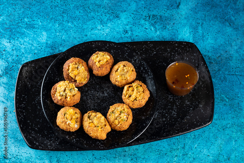 Pakistani spicy gol gappay, indian pani puri and bangali fuchka full of chaat masala with sour water in a dish isolated on marble background top view of indian street food