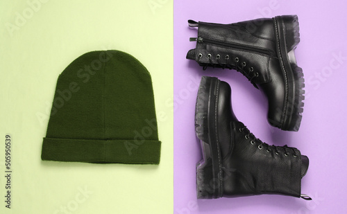 Leather boots and hat on green pink pastel background. Top view. Flat lay
