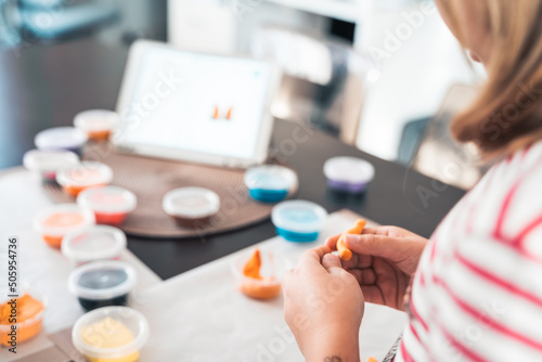 Bilde på lerret Little girls sculpt figurines crafts from air plasticine, modeling dough