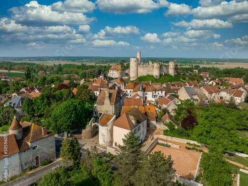 Aerial view of Billy castle in Central France with donjon, four semi circle towers and fortified gate house on a hilltop photo