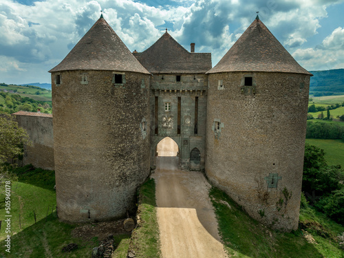 Fortified gate house flanked by two round towers in the imposing castle of Berze Le Chatel in Burgundy with 14 towers and three enclosures in Central France photo