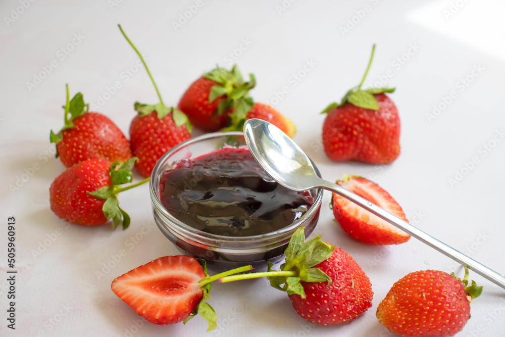 Strawberry jam, fresh berries on a light background Strawberry jam, fresh berries on a light background