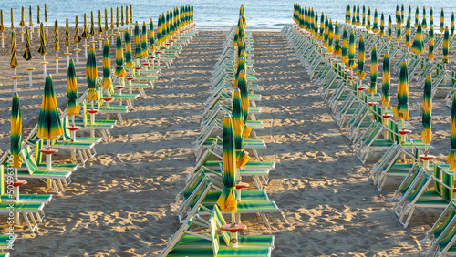 Gabicce, Italy. View of colorful beach umbrellas. Summer holidays at the sea. General contest and location. Beach umbrellas closed due to lack of tourists. Relaxing context. Morning time