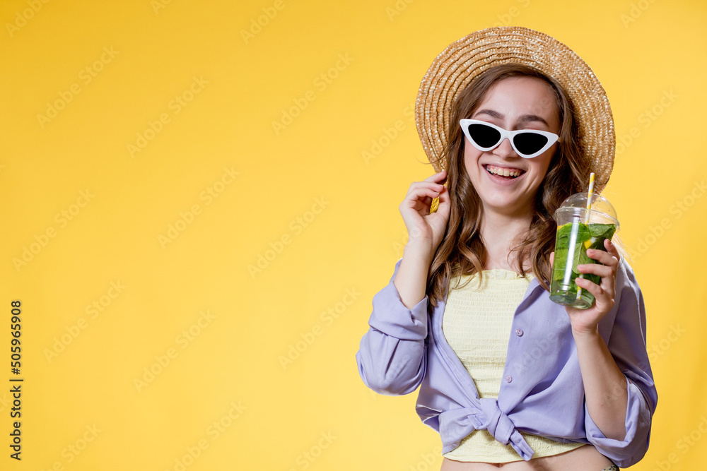 Summer refreshment. Cold beverage. Happy woman in sunglasses holding plastic glass of mojito. Non-alcoholic drink. Detox lemonade. Summer refreshment. Cold beverage. Happy woman in sunglasses holding plastic glass of mojito. Non-alcoholic drink. Detox lemonade.