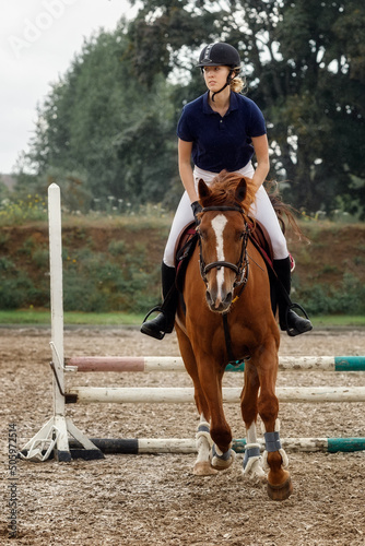 Beautiful lady jumping with her stud horse. © Linas T