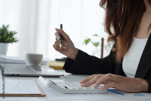 Woman calculate domestic bills at home. Businesswoman using calc