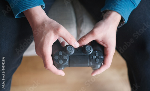 Joystick for game console in the mans hands.The concept of leisure and entertainment