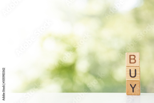 Buy Word In Wooden Cubes on green summer background