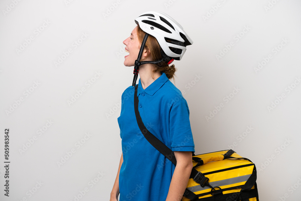 Young English woman with thermal backpack isolated on white background laughing in lateral position Young English woman with thermal backpack isolated on white background laughing in lateral position