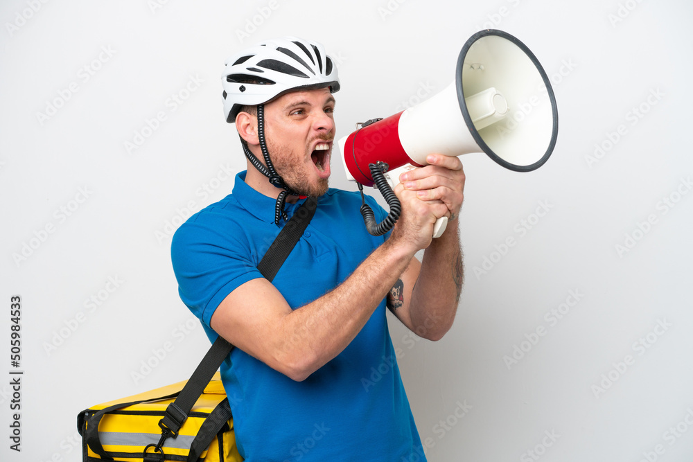 Young brazilian man with thermal backpack isolated on white background shouting through a megaphone Young brazilian man with thermal backpack isolated on white background shouting through a megaphone
