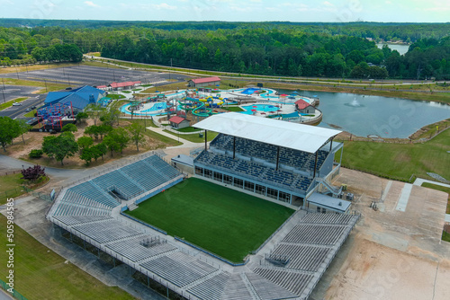 an aerial shot of a stadium on the banks of the Indian Lake surrounded by a pool with waterslides and vast miles of lush green trees  at Lake Spivey Recreation Center in Jonesboro Georgia USA photo