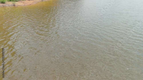 gorgeous aerial footage of the rippling silky brown waters of the Indian Lake at Lake Spivey Recreation Center in Jonesboro Georgia USA photo