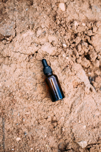 bottle mockup with dropper on nature background.