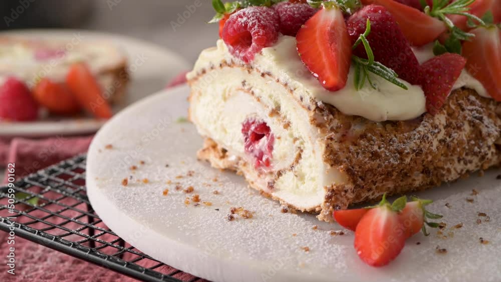 Meringue roll cake with cream, raspberries. Roulade, summer dessert served in ceramic plate. Meringue roll cake with cream, raspberries. Roulade, summer dessert served in ceramic plate.