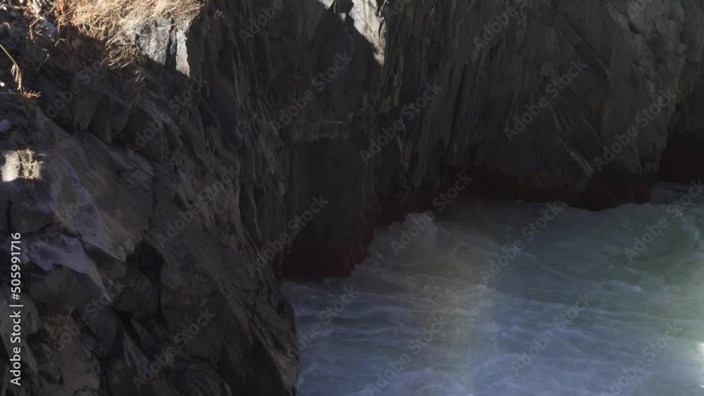 Rapid flow of a mountain river in a rocky gorge in the mountains Rapid flow of a mountain river in a rocky gorge in the mountains