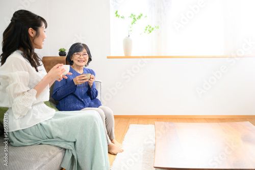 Elderly mother and daughter relaxing in the living room Wide angle