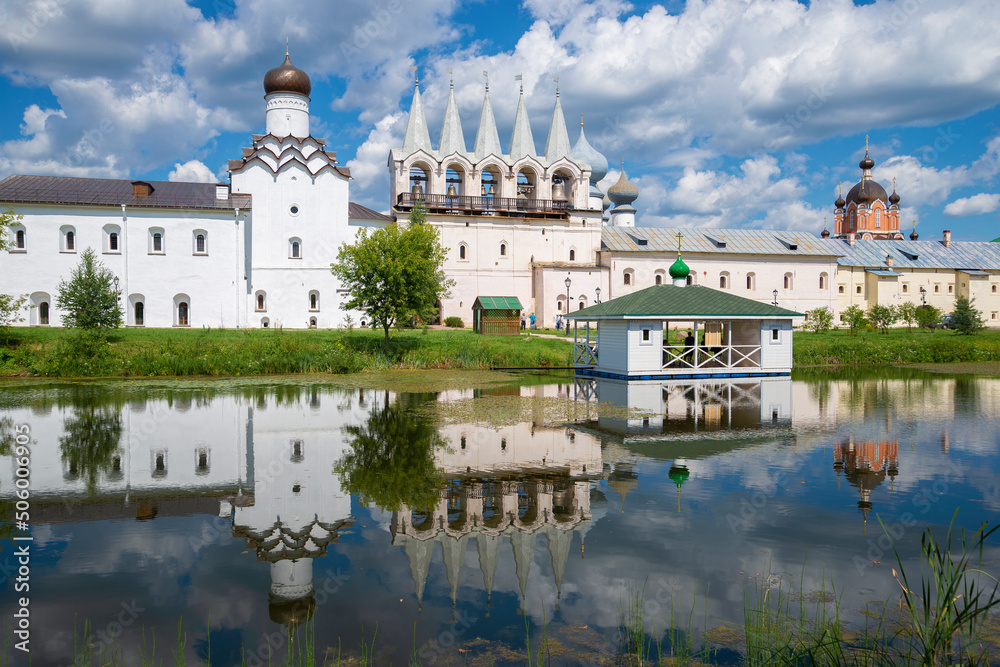 Sunny July day on the monastery pond. Tikhvin Assumption Monastery. Leningrad region, Russia