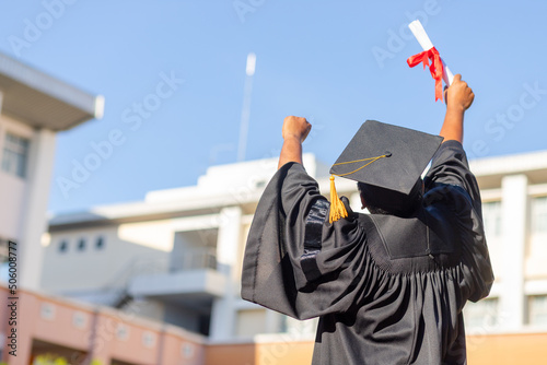 Graduates in gowns and graduation caps with diplomas