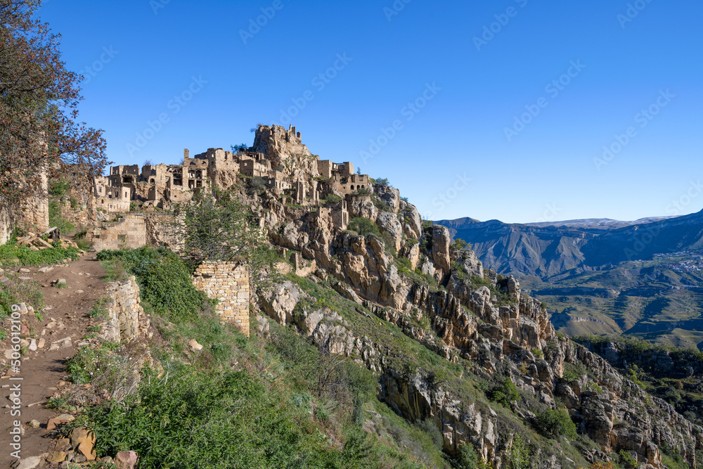 Ruins of the abandoned mountain village Gamsutl in a mountain landscape on a September morning. Republic of Dagestan, Russia