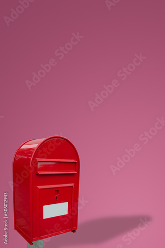 Canvas Print Cover page with big fancy red metal postbox with white empty note space for address isolated at pink gradient background with copy space