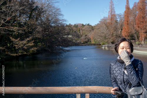 Happy woman smiling looking at camera at Inokashira Park in Kichijoji, Tokyo