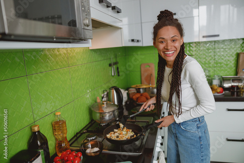 Mixed-race young attractive woman cooking in the kitchen. Healthy Food. Dieting concept