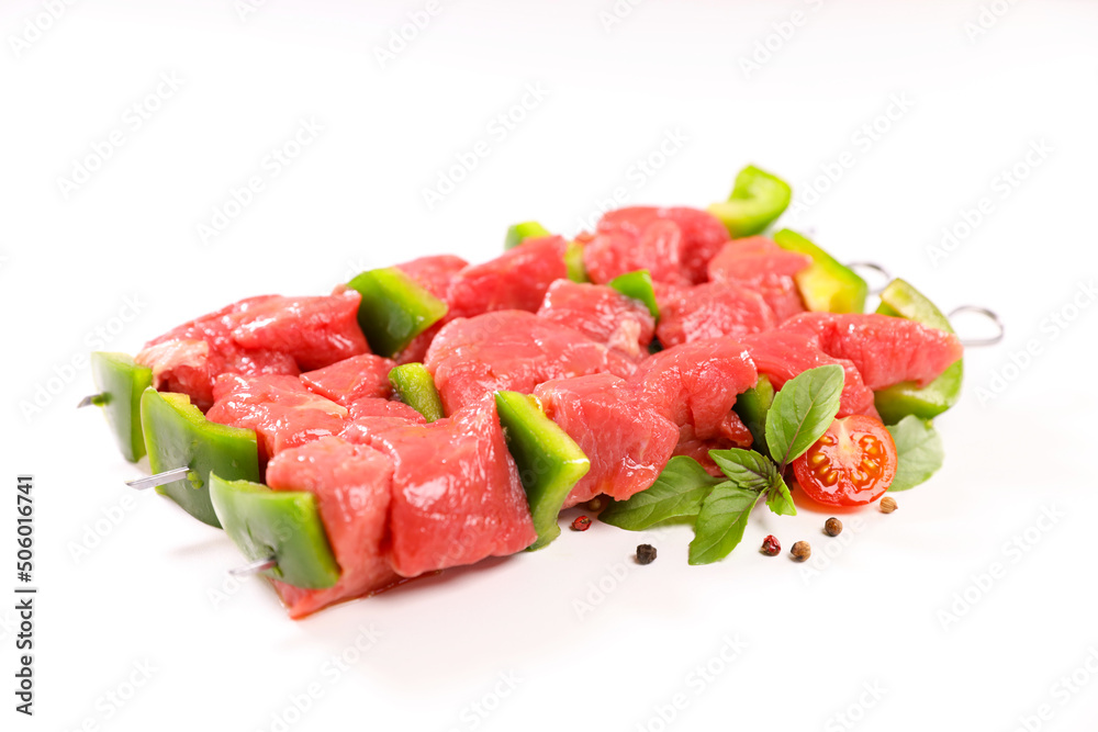 raw barbecue beef skewers and herbs