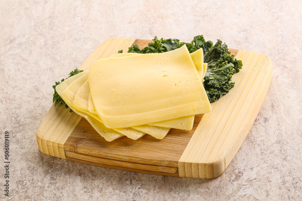 Sliced Gouda cheese over board Sliced Gouda cheese over board