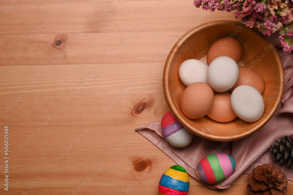Painted Easter eggs with spring flowers on wooden background. Happy Easter concept. Painted Easter eggs with spring flowers on wooden background. Happy Easter concept.