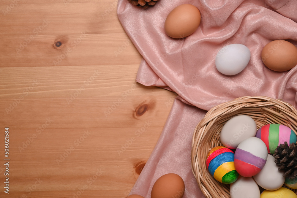 Colorful painted Easter eggs in wicker basket on wooden background with copy space. Colorful painted Easter eggs in wicker basket on wooden background with copy space.