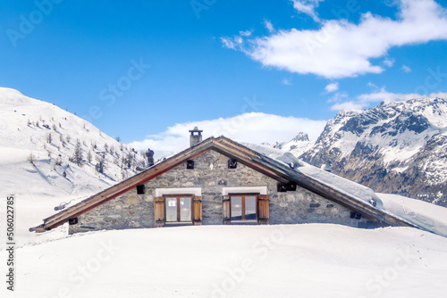 An old chalet in the Swiss Alps near Piz Covatsch after an heavy snowfall