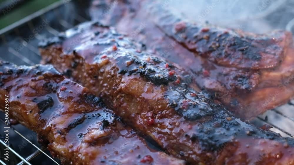 delicious beef or pork ribs frying on a charcoal grill delicious beef or pork ribs frying on a charcoal grill