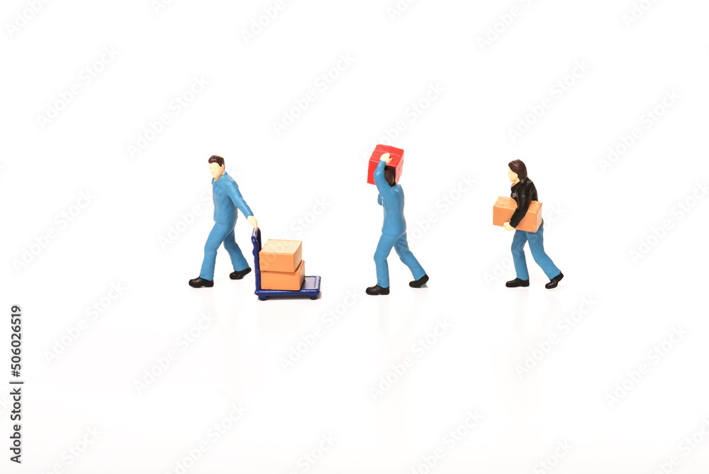 Miniature people, man carrying box using for logistic and business concept Miniature people, man carrying box using for logistic and business concept