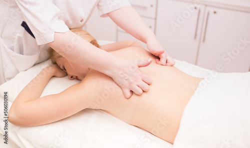 Massage on the problem areas of the body for weight loss and body correction. Master massage therapist makes anti-cellulite massage to a young girl. Spa treatments relaxing massage. chiropractor