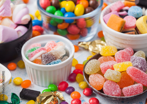 Εκτύπωση καμβά Jelly sugar gums candies on blue background with liquorice allsorts and strawberry marshmallow and large variety of sweets and candies