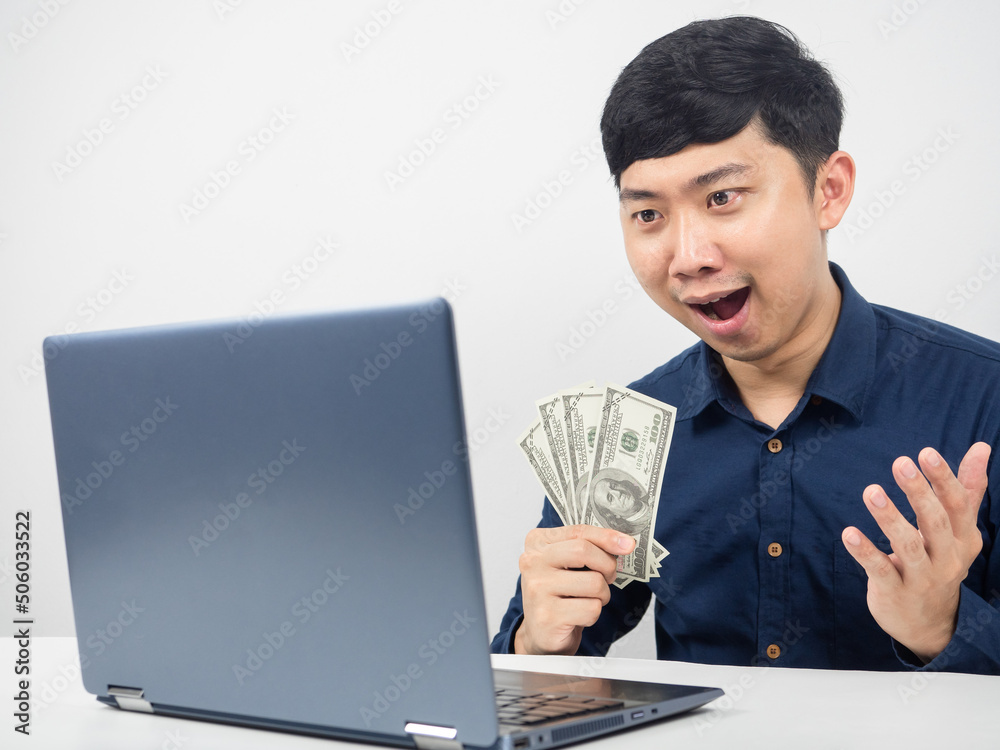 Man sitting and looking at laptop feeling amazed with earn money Man sitting and looking at laptop feeling amazed with earn money
