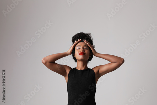 Gorgeous African American young woman poses on white background. Mock-up.