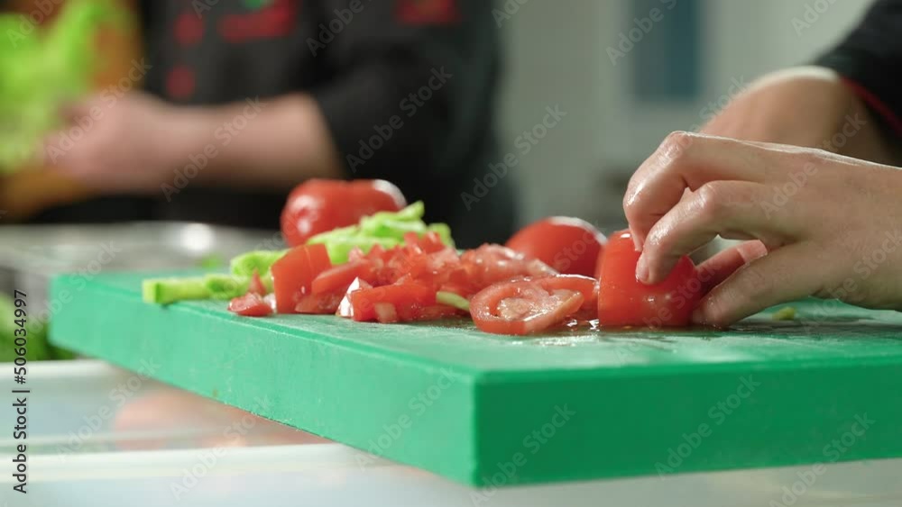 The chef is slicing tomatoes.
The chef is slicing tomatoes with a knife.
The chef is slicing tomatoes.
The chef is slicing tomatoes with a knife.