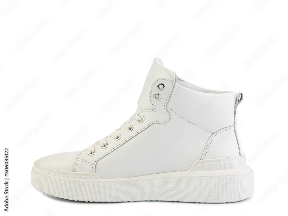 White classic leather trainers. Casual women's style. White lacing and white rubber soles. Isolated close-up on white background. White classic leather trainers. Casual women's style. White lacing and white rubber soles. Isolated close-up on white background.